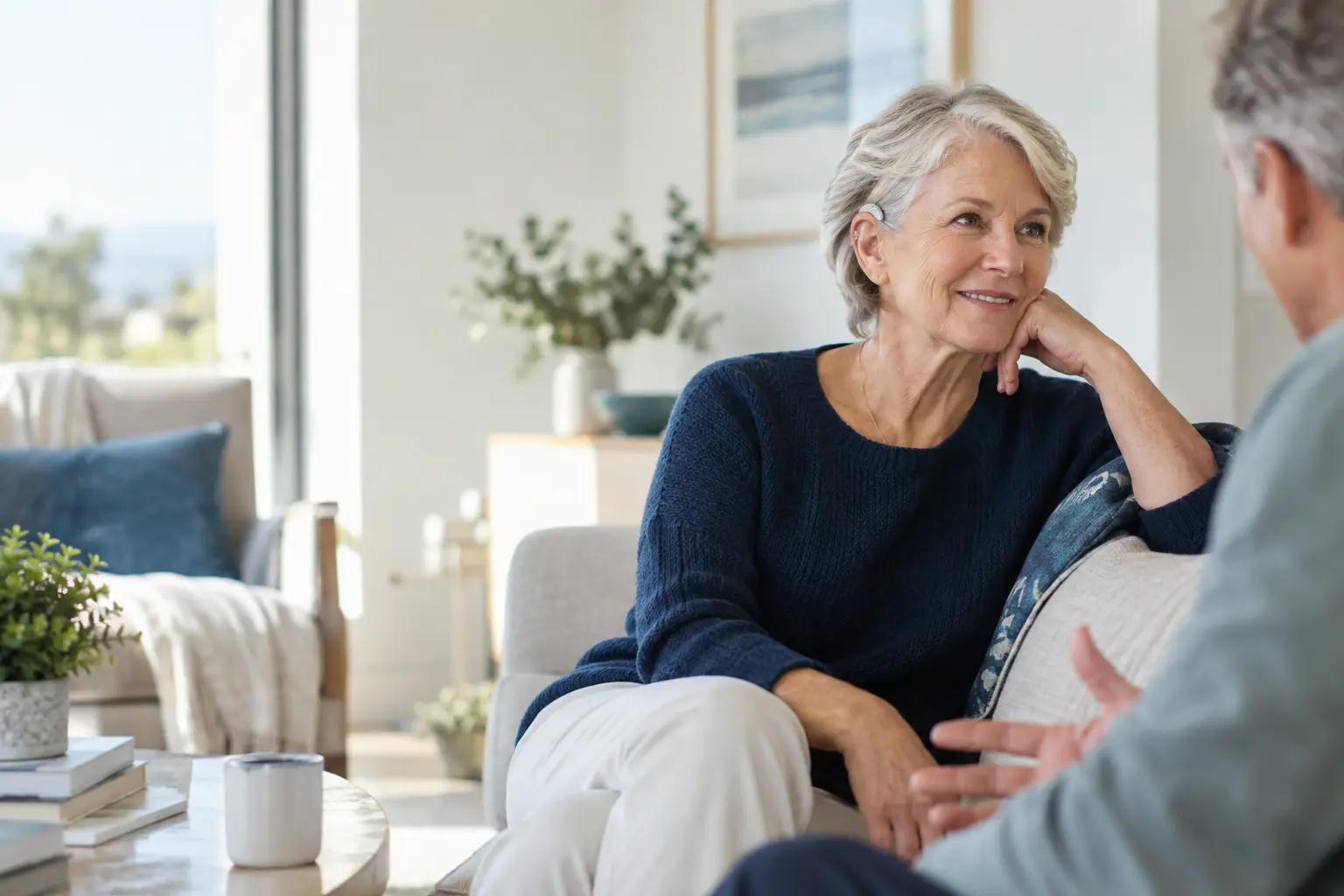 Older adult with a subtle hearing aid enjoying conversation at home